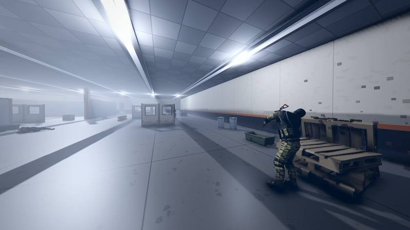 A player in camo ducks behind stacked pallets in the bright arena hall